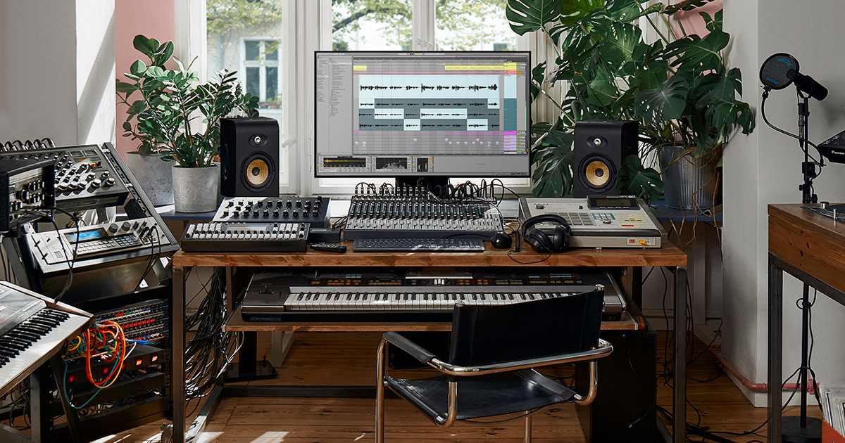 Hunter Wiley's studio workspace with synthesizers, speakers, and Ableton Live on screen.